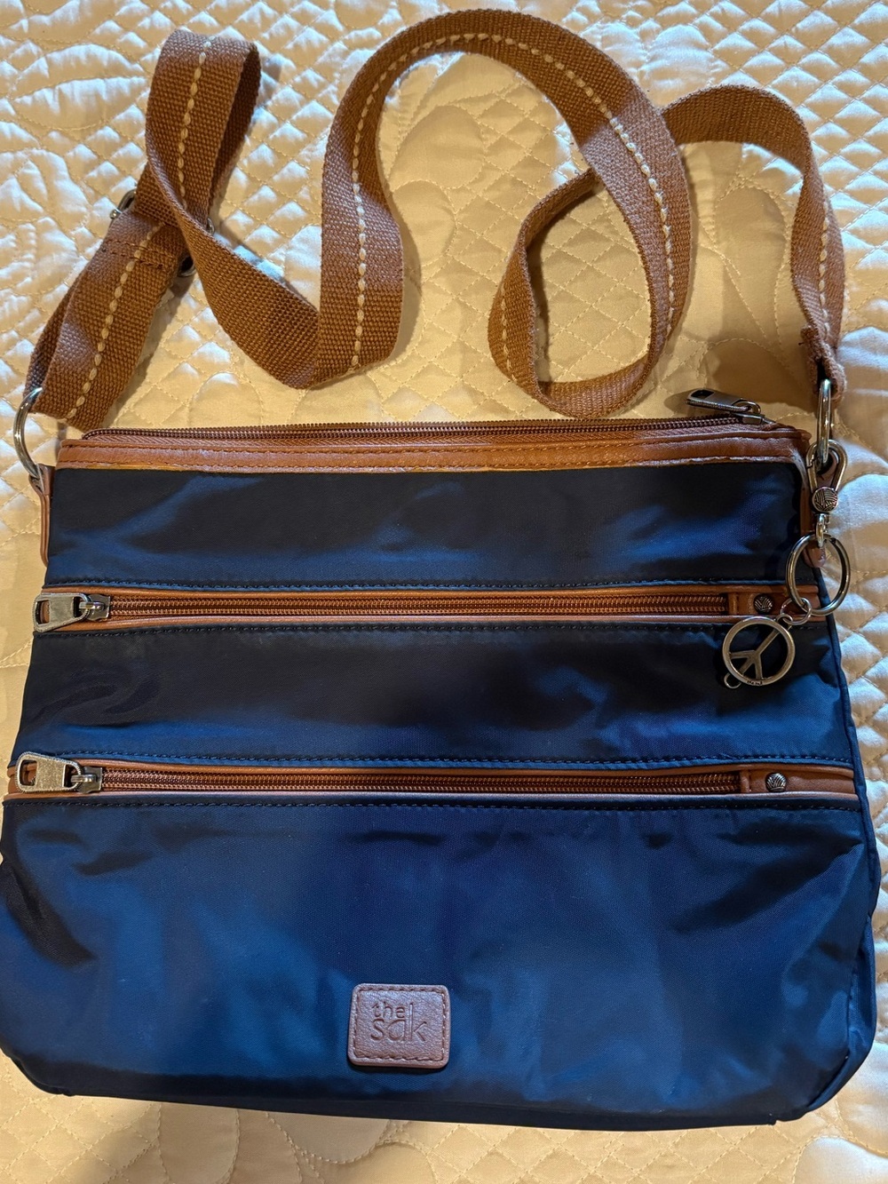 The Sak Esperato Nylon Crossbody Bag navy blue contrasting brown trim
